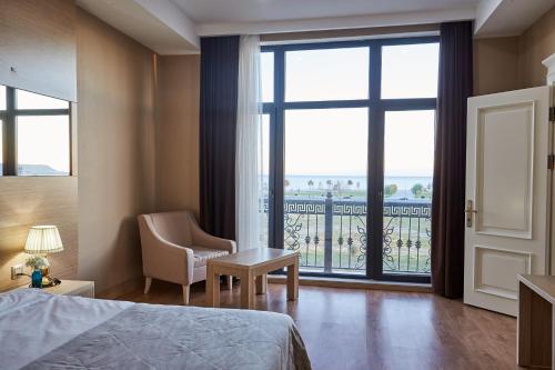 a hotel room with a bed and a large window at NOBEL Hotel in Baku