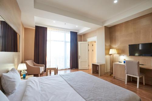 a hotel room with a bed and a television at NOBEL Hotel in Baku