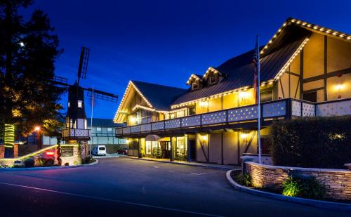 a building with lights on a street at night at Kronborg Inn in Solvang