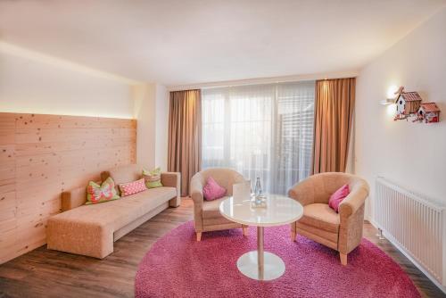 a living room with a couch and chairs and a table at Hotel Restaurant Der Engel, Sasbachwalden in Sasbachwalden