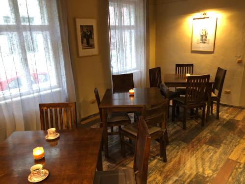 a dining room with wooden tables and chairs at Poet Pastior Residence in Sibiu