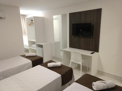 Ένα ή περισσότερα κρεβάτια σε δωμάτιο στο Hotel Jucazinho