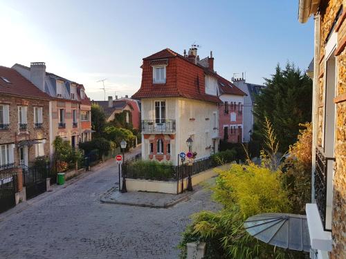 an empty street in a town with a house at Bonjour Paris in Paris