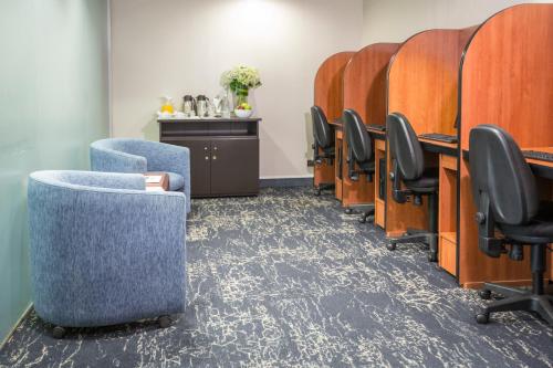 a conference room with chairs and a row of tables at Delfines Hotel & Convention Center in Lima