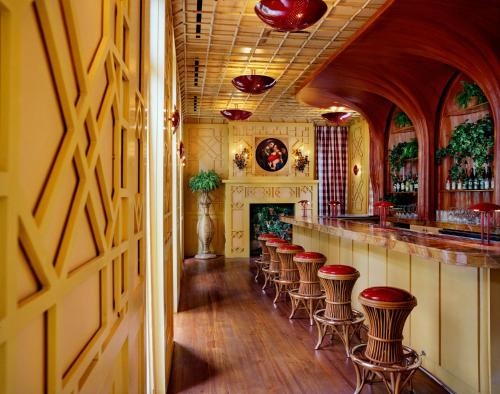 a bar with a row of bar stools at Hotel Peter and Paul in New Orleans