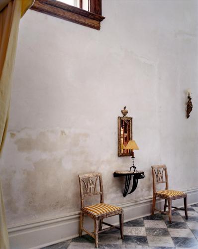 two chairs and a table with a lamp on a wall at Hotel Peter and Paul, an Ash Hotel in New Orleans
