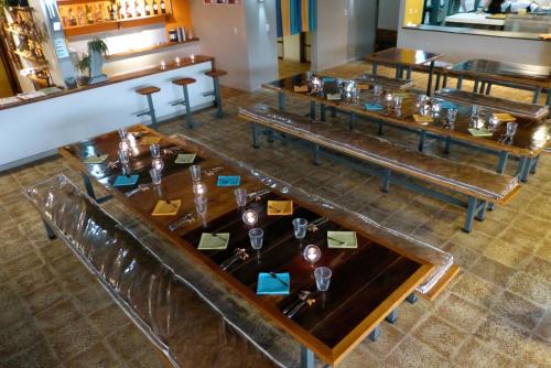 a dining room with tables with glasses on them at Celeste Mountain Lodge in Bijagua