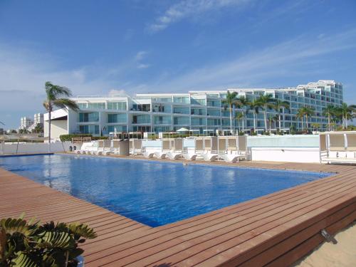 a large hotel with a swimming pool and a building at ARIA OCEAN ACQUA NUEVO VALLARTA in Nuevo Vallarta