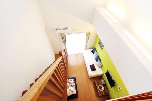 a room with a staircase with a door and a stair case at Chura Minpaku Ishigaki in Ishigaki Island