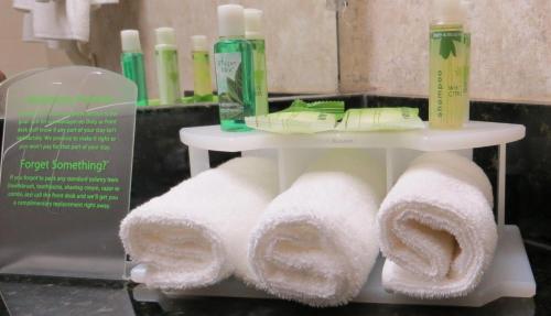 a display of towels on a shelf in a bathroom at Holiday Inn Express- West Sacramento, an IHG Hotel in West Sacramento