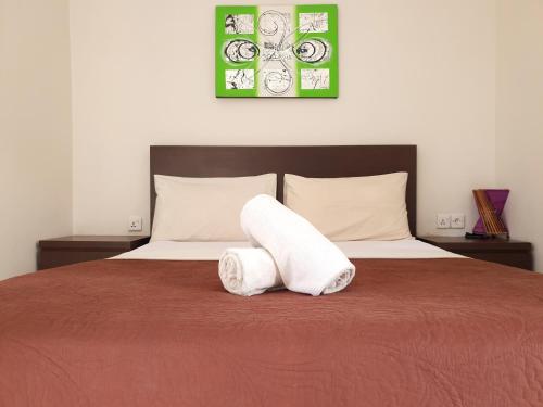 a bedroom with a bed with two towels on it at Naturela in Uluwatu
