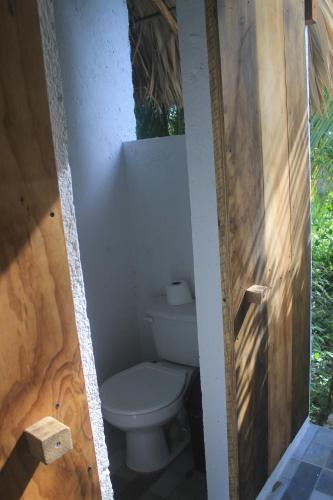 a bathroom with a toilet in a bathroom stall at Guarumbo in Bacalar