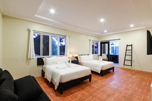 a living room with two beds and a couch at Mario Dive Resort in Panglao