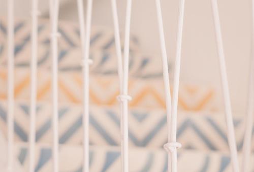 a close up of a white fence with cookies in the background at Kos One Hostel in Canggu