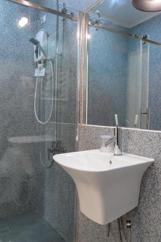 a bathroom with a sink and a shower at Mario Dive Resort in Panglao