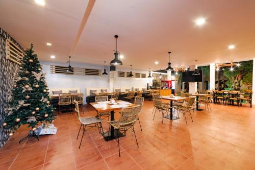 a restaurant with a christmas tree and tables and chairs at Mario Dive Resort in Panglao