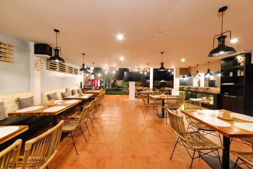 a dining room with wooden tables and chairs at Mario Dive Resort in Panglao