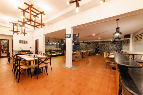 a restaurant with wooden floors and tables and chairs at Mario Dive Resort in Panglao