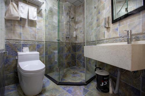 a bathroom with a toilet and a sink and a shower at Shanghai Chi Chen Boutique Hotel in Shanghai