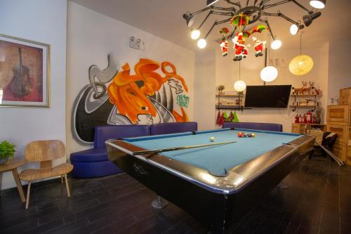 a living room with a pool table and a painting at Shanghai Chi Chen Boutique Hotel in Shanghai