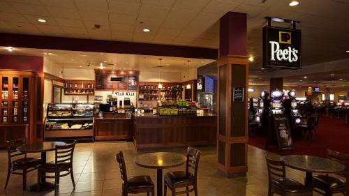 a restaurant with tables and chairs in a mall at Best Western Plus Boomtown Casino Hotel in Reno
