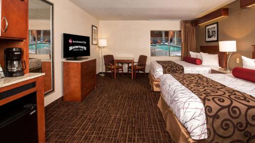 a hotel room with two beds and a television at Best Western Plus Boomtown Casino Hotel in Reno