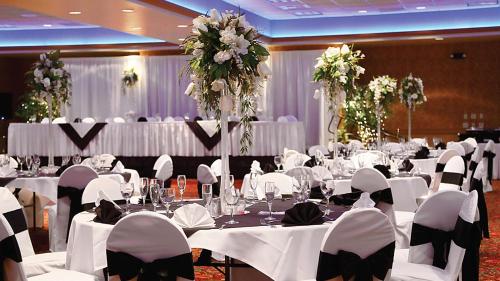 a banquet hall with white tables and chairs and flowers at Best Western Plus Boomtown Casino Hotel in Reno
