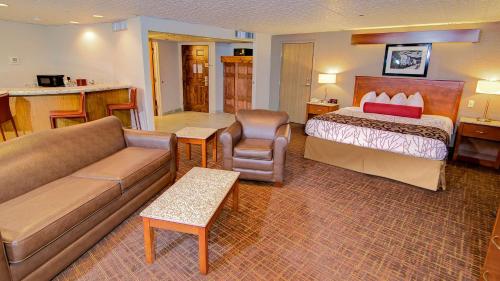a hotel room with a bed and a couch at Best Western Plus Boomtown Casino Hotel in Reno