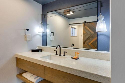 a bathroom with a sink and a large mirror at Hotel Becket, BW Signature Collection in South Lake Tahoe