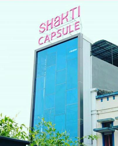 a large building with a sign on top of it at Hotel Shakti Capsule in Bandung