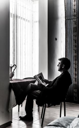 a man sitting in a chair with a laptop at Yacht Lago Titicaca in Ichu