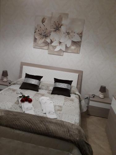 a bedroom with a bed with two pictures on the wall at A casa di Simona in Monreale