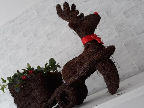 a stuffed bear sitting next to a potted plant at A casa di Simona in Monreale