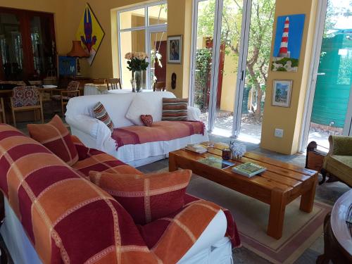 a living room with couches and a coffee table at Steytlerville Villa Guest house in Steytlerville