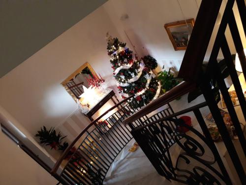 a living room with a christmas tree and a staircase at A casa di Simona in Monreale