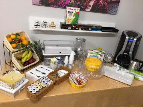 a table topped with baskets of fruit and other food at A casa di Simona in Monreale