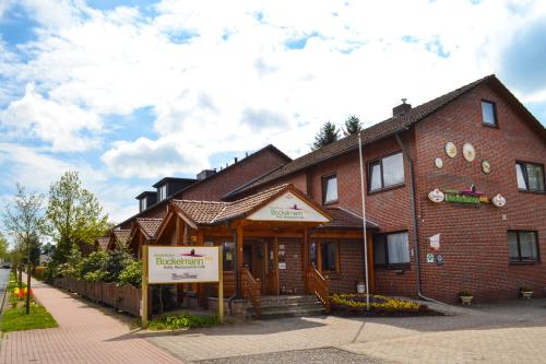 a brick building with a sign in front of it at Hotel Bockelmann in Bispingen