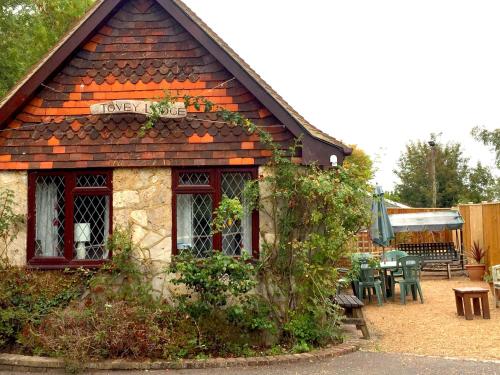 a small building with a table and chairs at Tovey Lodge in Hassocks