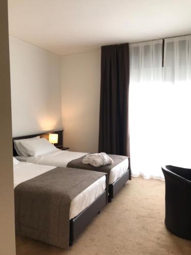 Ένα ή περισσότερα κρεβάτια σε δωμάτιο στο Hotel Eurorest