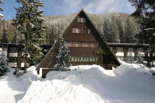 a large house with snow in front of it at Horská chata Primula - 1000 m nad morom in Zuberec