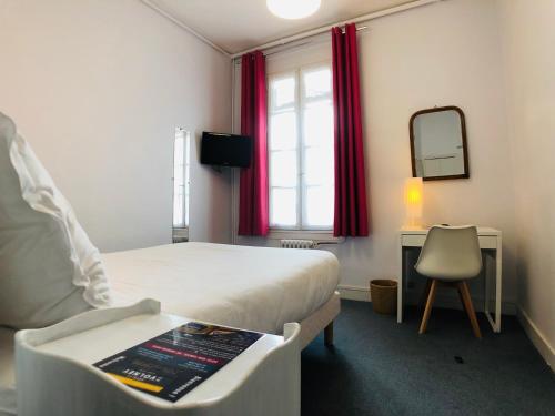a bedroom with a bed and a mirror and a chair at Cit'Hotel Le Volney in Saumur