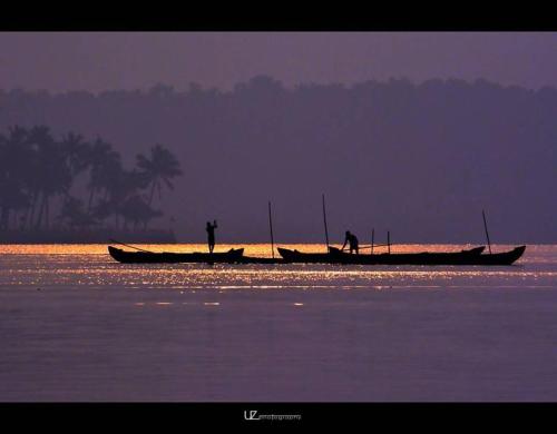 two people standing on a boat in the water at Munroe Meadows in Munroe Island