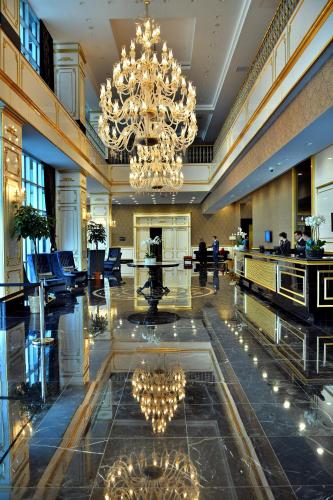 a hotel lobby with a large chandelier and a large lobby at Downtown Ankara Hotel in Ankara