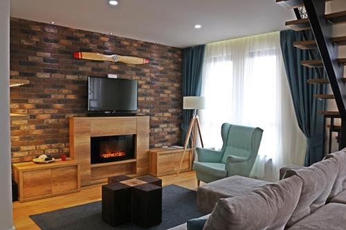 a living room with a couch and a fireplace at Vip Casa Club Zlatibor in Zlatibor