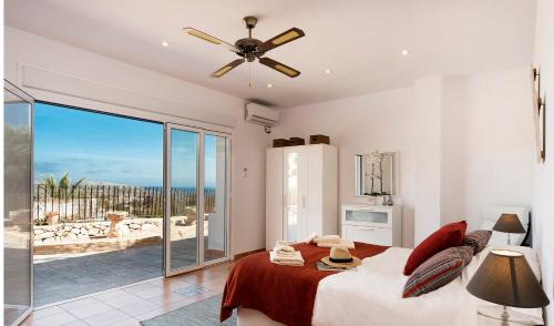 a bedroom with a bed and a view of the ocean at Villa Beniarres Guest House B&B in Moraira in Moraira