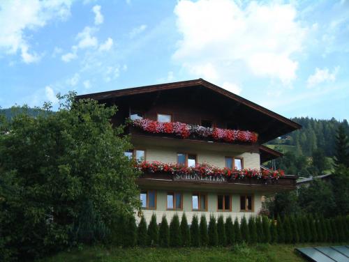 a building with flowers on the side of it at Haus Schönleiten in Wagrain