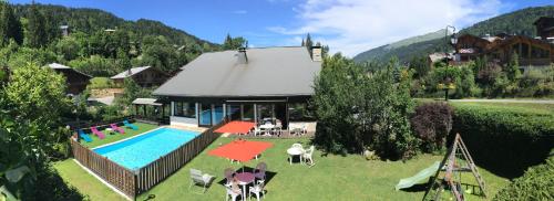 an aerial view of a house with a swimming pool at Hotel Le Soly in Morzine