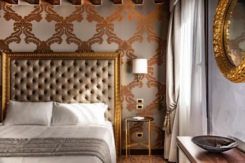 a bedroom with a bed with a gold frame at Palazzo San Lorenzo in Venice