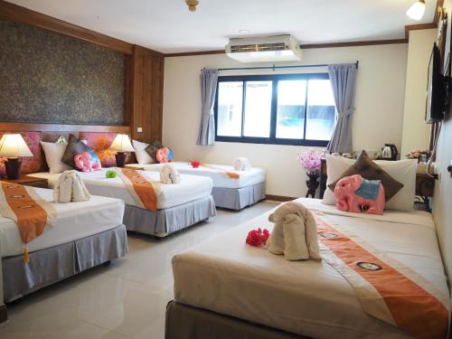 a bedroom with four beds in a room at Your Place Inn in Karon Beach