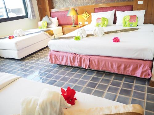 a hotel room with two beds with stuffed animals on them at Your Place Inn in Karon Beach